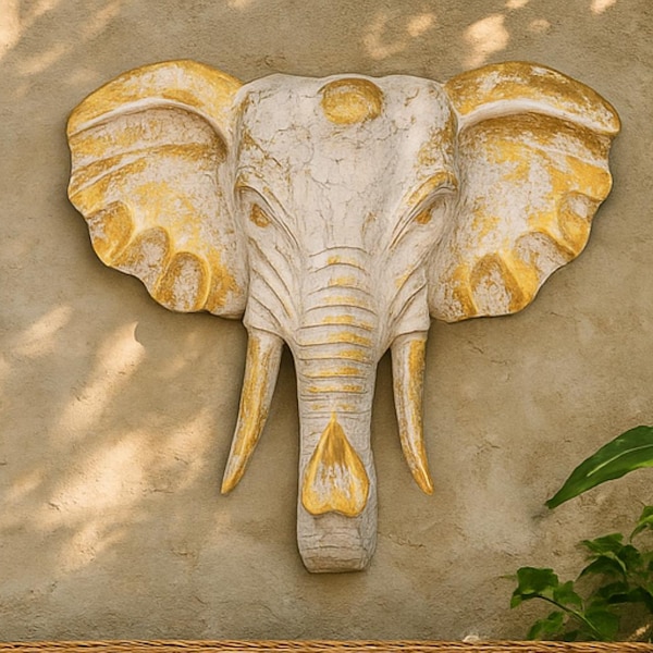 Decoración de pared con cabeza de elefante tallada a mano en madera, estilo boho con acabado dorado y blanqueado.