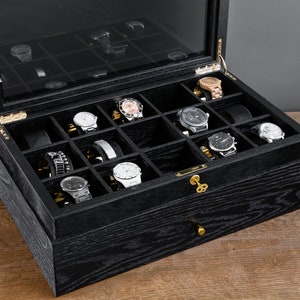 Black oak watch box with furry watch holders, lock and hinge detail