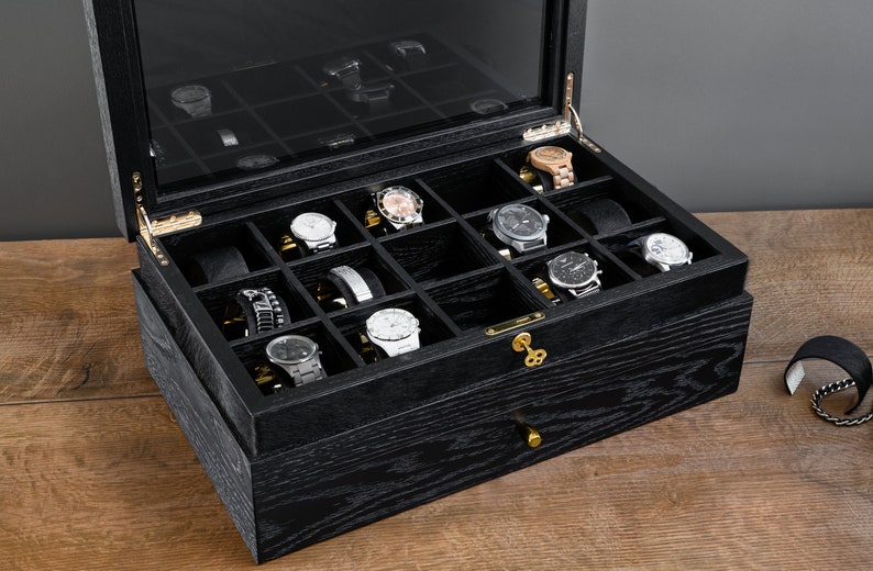 Black oak watch box with furry watch holders, lock and hinge detail