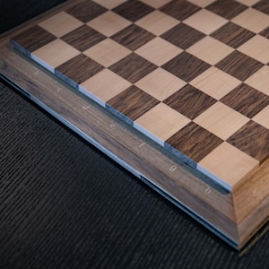 perspektive for letters engraved on thewalnut board. The engraved Letters filled with mapple wooden letters.