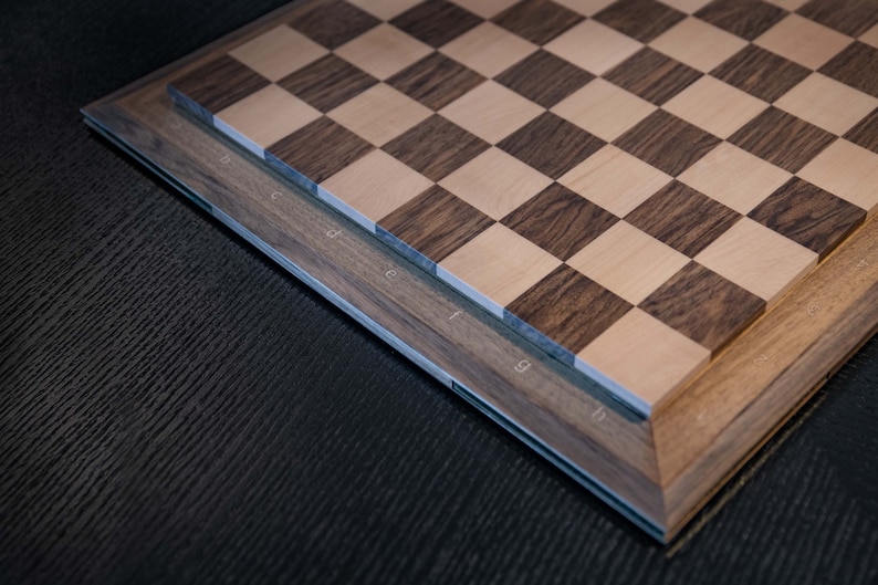 perspektive for letters engraved on thewalnut board. The engraved Letters filled with mapple wooden letters.