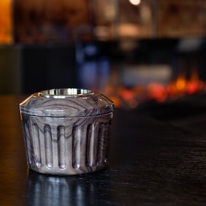 May include: A dark wood and brass incense burner with a fluted design. The burner is sitting on a dark wood table.