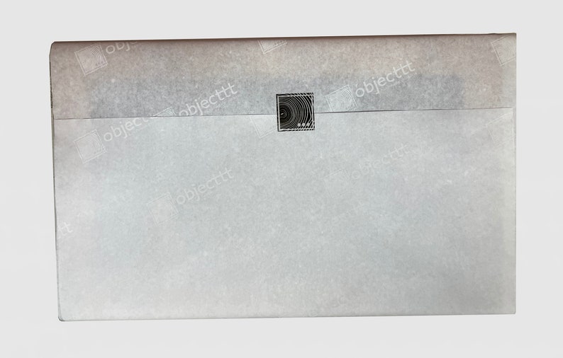 May include: A white envelope with a black and white circular design stamp in the center.