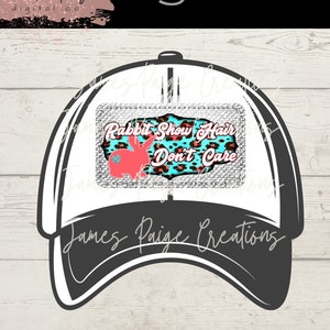 May include: White and black baseball cap with a silver glitter patch that says "Rabbit Show Hair Don't Care" in pink and blue letters on a turquoise and pink leopard print background.