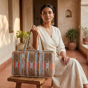 May include: A rectangular quilted tote bag featuring a repeating pattern of stylized tigers in shades of orange, blue, and black. The bag has two sturdy fabric handles and a structured rectangular shape with visible stitching throughout the exterior.