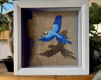 Macaw in flight - thinking outside the box | street art on recycled cardboard