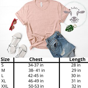 May include: A size chart for a t-shirt with measurements in inches for chest and length. The chart shows sizes S, M, L, XL, and XXL. The chart is on a white background.