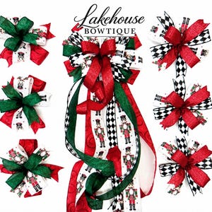 May include: A collection of decorative bows featuring a nutcracker pattern on white ribbon, accented with solid red and green ribbons and black and white checkered patterns. The text Lakehouse BOWTIQUE is centered at the top of the image.