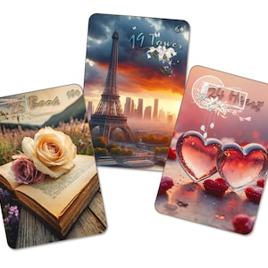 May include: Three decorative cards with romantic themes. One card features a rose on an open book, another the Eiffel Tower, and the last two hearts. Each card has text: "26 Book 100", "19 Tower 64", and "24 Heart".