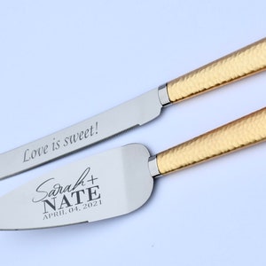 May include: Gold wedding cake knife and server set with engraved text "Love is sweet!" and "Sarah + Nate April 04, 2021".