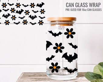 May include: A pre-sized can glass wrap with a Halloween theme. The design features black bats and orange flowers on a clear glass background. The wrap is sized for a 16oz can glass.