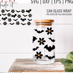 May include: A pre-sized can glass wrap with a Halloween theme. The design features black bats and orange flowers on a clear glass background. The wrap is sized for a 16oz can glass.