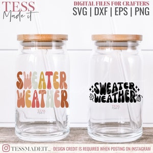 May include: Two clear glass tumblers with lids and straws. One tumbler has a colorful retro-style graphic that says "Sweater Weather". The other tumbler has a black graphic that says "Sweater Weather" with a pumpkin and leaves.