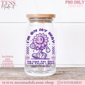 May include: Purple and pink graphic design on a clear glass jar with a wooden lid. The design features a cartoon sunflower with a smiling face walking and the text "I'm on my way" and "To find the shit you think I give. Might not be back".