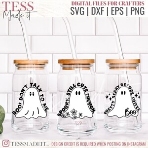 May include: Three glass jars with wooden lids and straws. Each jar has a different ghost design with text. The first jar says "Boo! Don't Talk To Me." The second jar says "Spooky Still Cute Though." The third jar says "Pretty Scary Before Coffee. Boo."