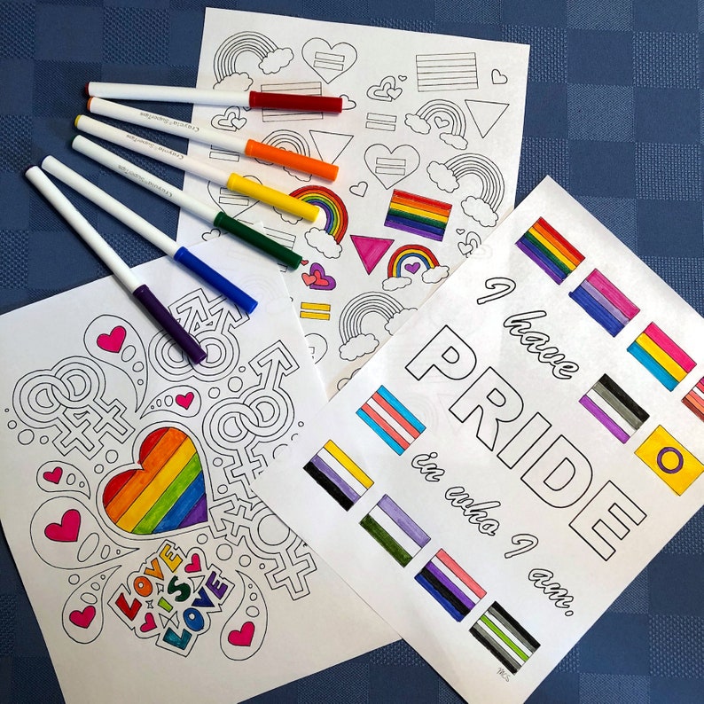 Three coloring pages with various LGBTQIA+ symbols and flags. There are colorful markers at the top left of the screen. The pages are partially colored in.