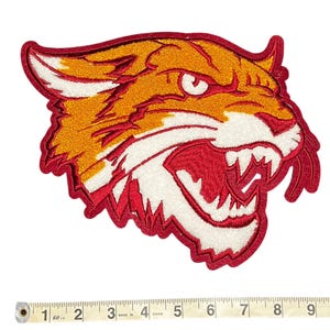 May include: Embroidered patch featuring a snarling tiger head in shades of orange, red, and white. The patch has a detailed design with a red border. The patch measures approximately 4 inches wide.