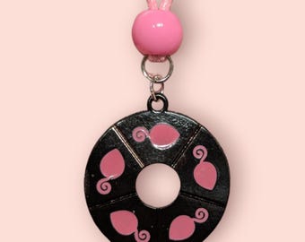 May include: A black metal necklace with a pink bead and a round pendant featuring five pink ladybug silhouettes.