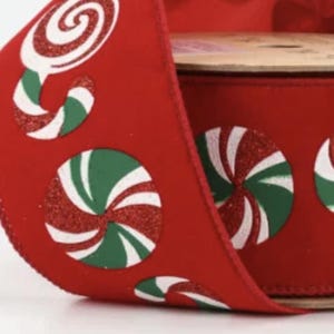 May include: Red ribbon with a white and green peppermint candy design. The candy is printed on the ribbon and has a glittery texture.