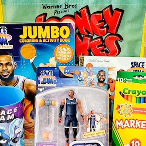 May include: A collection of Space Jam themed merchandise, including a LeBron James action figure, coloring book, crayons, and a Looney Tunes tote bag. The items feature vibrant colors and the Space Jam logo.
