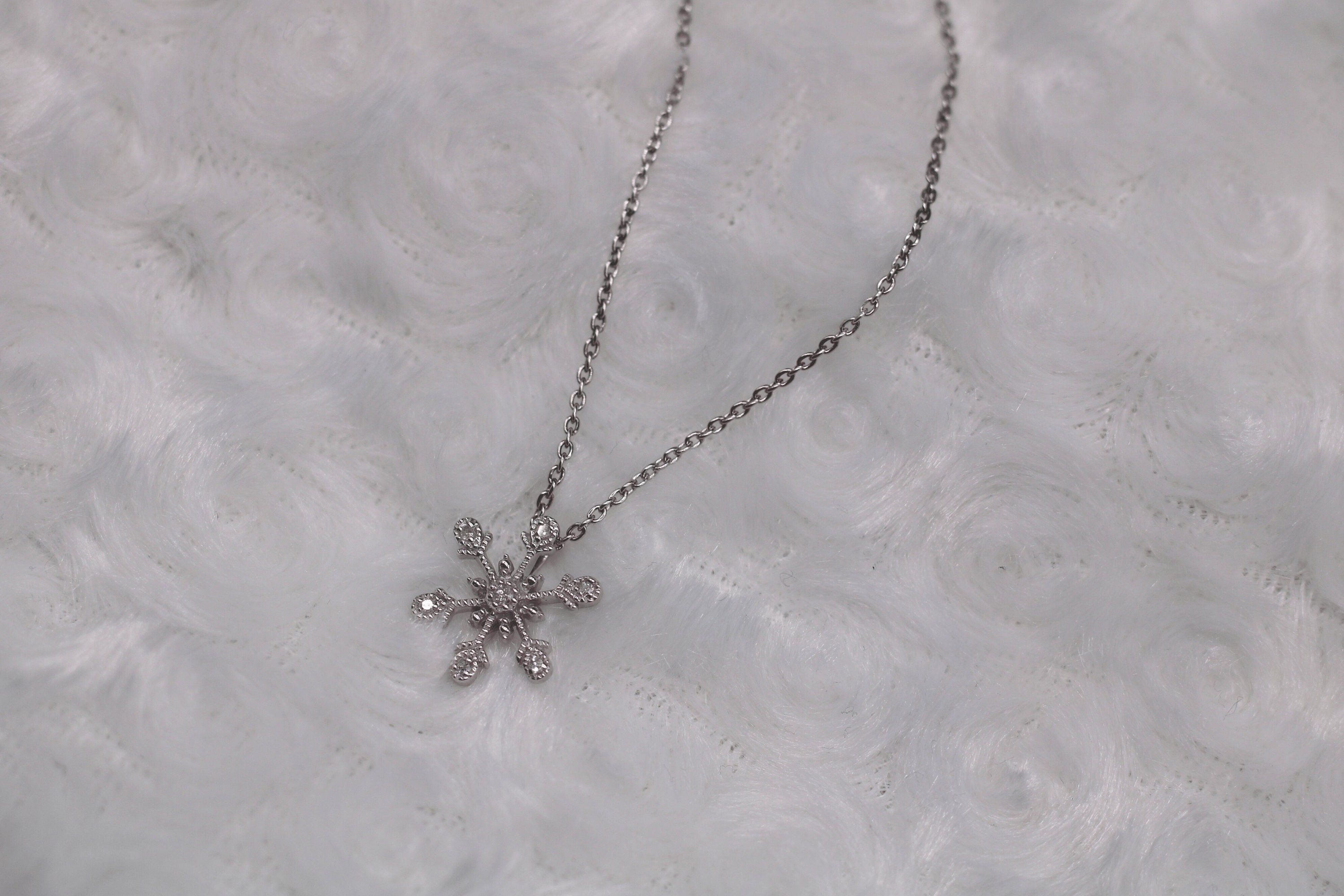 LOT:307 | TIFFANY & CO. - a platinum diamond snowflake pendant.