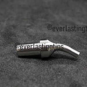 May include: A silver welding tip with a curved nozzle. The tip is designed for use with a welding torch.