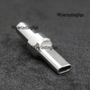 May include: A silver metal nozzle with a rectangular opening at the end. The nozzle is designed for use with a welding torch.