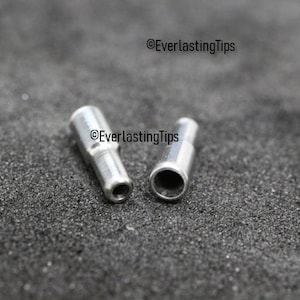 May include: Two silver metal pipe fittings, one with a closed end and one with an open end. ©EverlastingTips