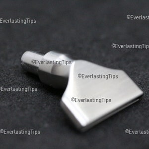 May include: A silver-coloured metal soldering tip with a flat, angled surface. The tip is designed for use with a soldering iron.