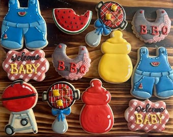 May include: A set of 10 decorated sugar cookies with a BBQ baby theme. The cookies feature a grill, a baby bottle, a watermelon, a bib, overalls, and a welcome baby sign.