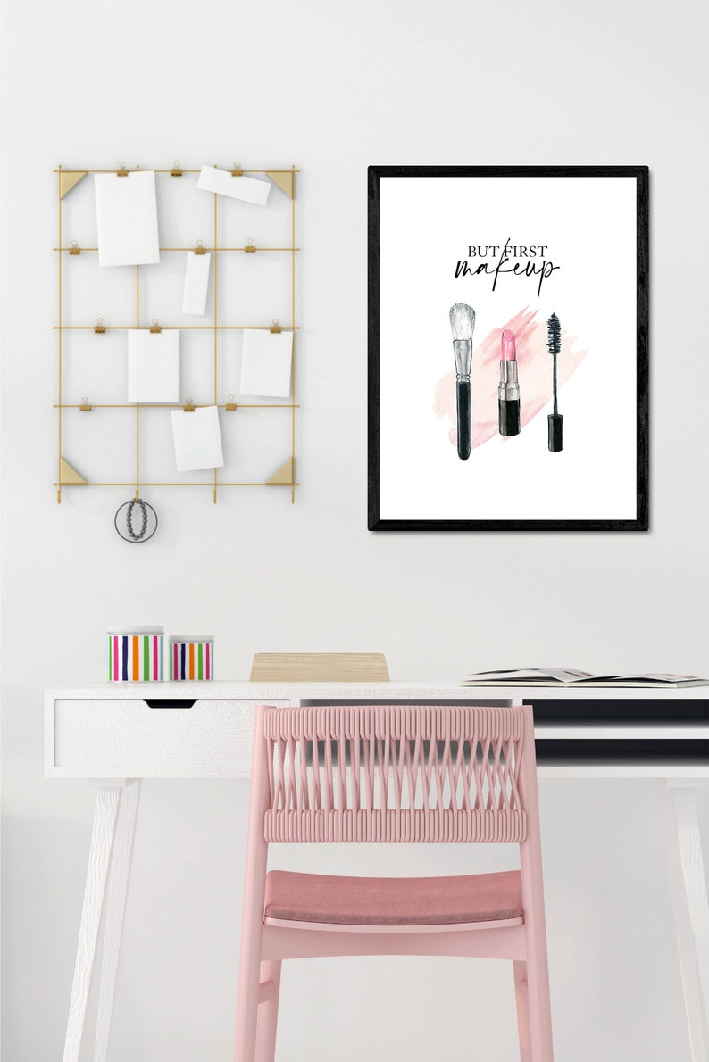 May include: A black framed print with the text "But first, makeup" in white. The print features a watercolor illustration of a makeup brush, lipstick, and mascara.