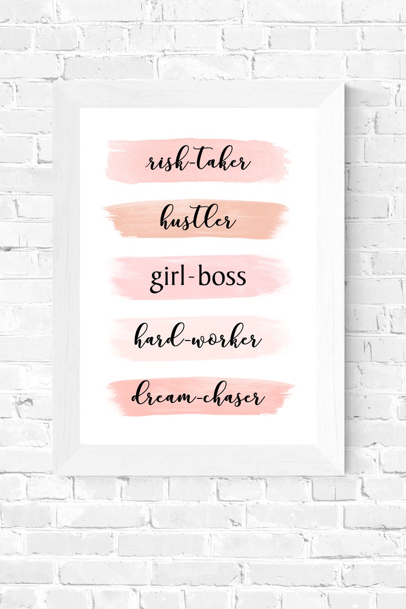 May include: A white framed print with pink watercolor brushstrokes and the words "risk-taker", "hustler", "girl-boss", "hard-worker", and "dream-chaser" in black cursive font.