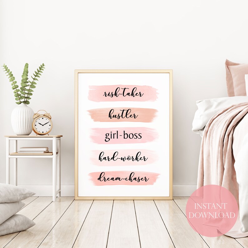 May include: A printable wall art design with a pink and peach watercolor background. The text reads "risk-taker, hustler, girl-boss, hard-worker, dream-chaser".