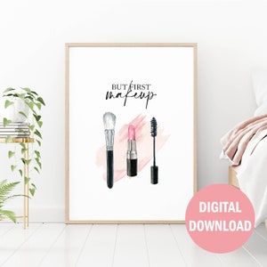 May include: A printable wall art design featuring a watercolor illustration of makeup brushes, lipstick, and mascara with the text "But first, makeup".
