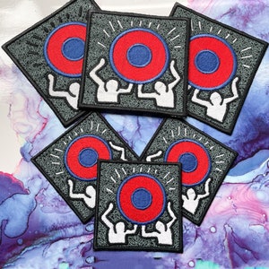 May include: Six gray square patches with white outlines. Each patch features two white figures lifting a red and blue circle with white rays emanating from the circle.