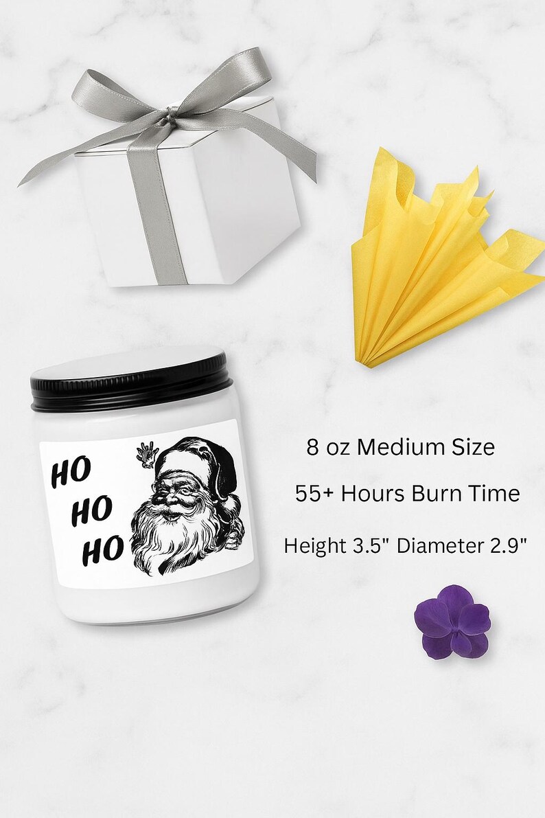 a medium-sized white jar with a Santa Claus illustration, a gift box, a yellow tissue paper, and a purple flower.