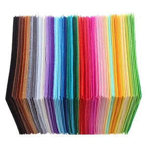 May include: A collection of felt sheets in a variety of colours, including brown, grey, purple, blue, green, red, pink, orange, and yellow. The sheets are stacked, displaying a range of hues suitable for crafting and DIY projects.