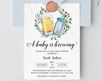 May include: A white rectangular baby shower invitation card featuring a watercolor illustration of a beer mug and a baby bottle inside a green leaf wreath. The text reads A baby is brewing, Sarah Jackson, Saturday Dec 19 2023, 12:00 PM, and address.