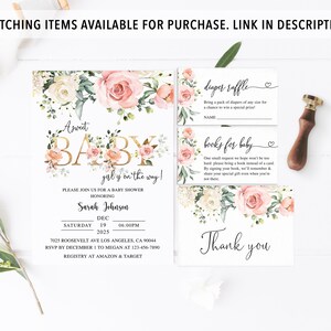 May include: A pink and white floral baby shower invitation with gold lettering. The invitation says "A Sweet Baby Girl is on the way!" and includes the date, time, and location of the shower. It also includes a diaper raffle and a books for baby request.