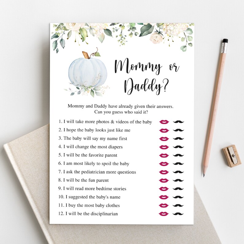 May include: A white baby shower game card with the text "Mommy or Daddy?" and a light blue pumpkin illustration. The card includes a list of statements with lips and mustache icons for guessing who said them.