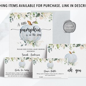 May include: Baby shower invitation set featuring a light blue pumpkin design with floral accents. The set includes an invitation, thank you card, and inserts for books and diapers. The text reads "A little pumpkin is on the way."