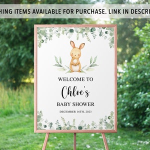 May include: A welcome sign for a baby shower with a watercolor illustration of a bunny rabbit and greenery. The sign says "Welcome to Chloe's Baby Shower December 16th, 2023".