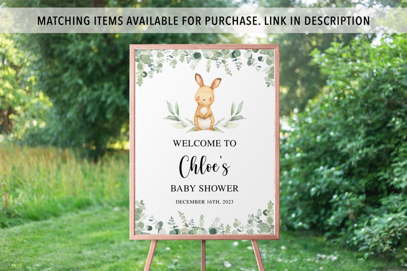 May include: A welcome sign for a baby shower with a watercolor illustration of a bunny rabbit and greenery. The sign says "Welcome to Chloe's Baby Shower December 16th, 2023".