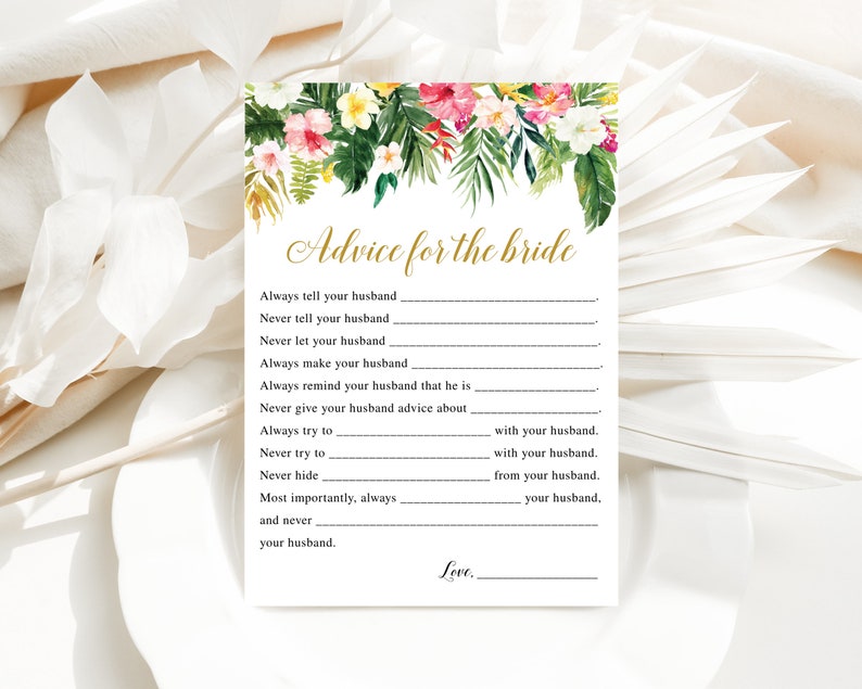 Peut inclure: Une carte blanche avec un motif floral en haut et le texte "Advice for the bride" en &eacute;criture dor&eacute;e. La carte contient une liste d'invites pour que les invit&eacute;s donnent des conseils &agrave; la mari&eacute;e, tels que "Always tell your husband..." et "Never let your husband..."