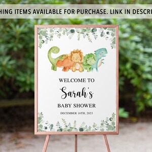 May include: Welcome to Sarah's Baby Shower sign with a green, white, and brown frame. The sign features a watercolor illustration of four dinosaurs in a line. The dinosaurs are green, orange, yellow, and blue. The text on the sign reads "Welcome to Sarah's Baby Shower December 16th, 2023".