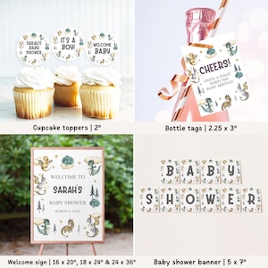 May include: A set of baby shower decorations featuring a woodland theme with dragons, stars, and trees. The set includes cupcake toppers, bottle tags, a welcome sign, and a banner. The colors are green, blue, gold, and white.