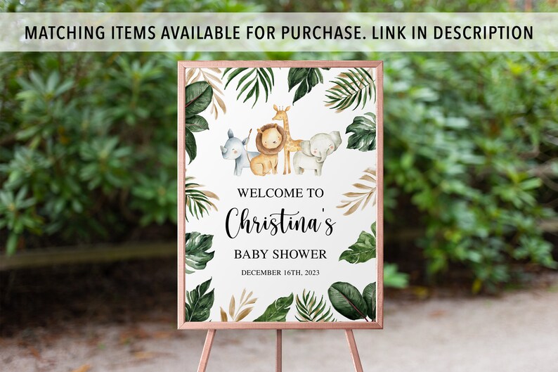 May include: A rectangular sign in a copper-colored frame featuring watercolor illustrations of a rhino, lion, giraffe, and elephant surrounded by green tropical leaves. The text reads: WELCOME TO Christina's BABY SHOWER DECEMBER 16TH, 2023.