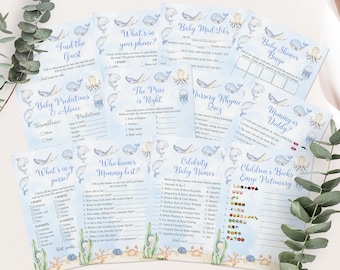 Puede incluir: Una colección de tarjetas de juegos para baby shower con un tema oceánico en acuarela. Las tarjetas presentan ilustraciones de ballenas, medusas y otras criaturas marinas. El texto en las tarjetas incluye títulos de juegos como "Baby Mad Libs" y "Baby Shower Bingo".
