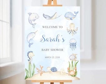 May include: A baby shower welcome sign with watercolour illustrations of sea creatures, including a dolphin, whale, and octopus. The sign says "Welcome to Sarah's Baby Shower" with the date March 15, 20XX.
