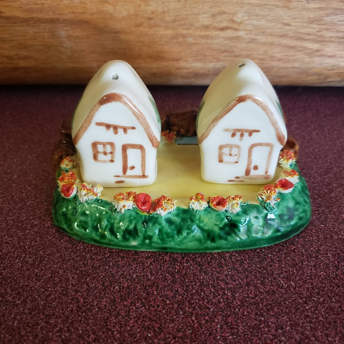 Vintage Salt and Pepper House shakers on a decorated piece of Etsy